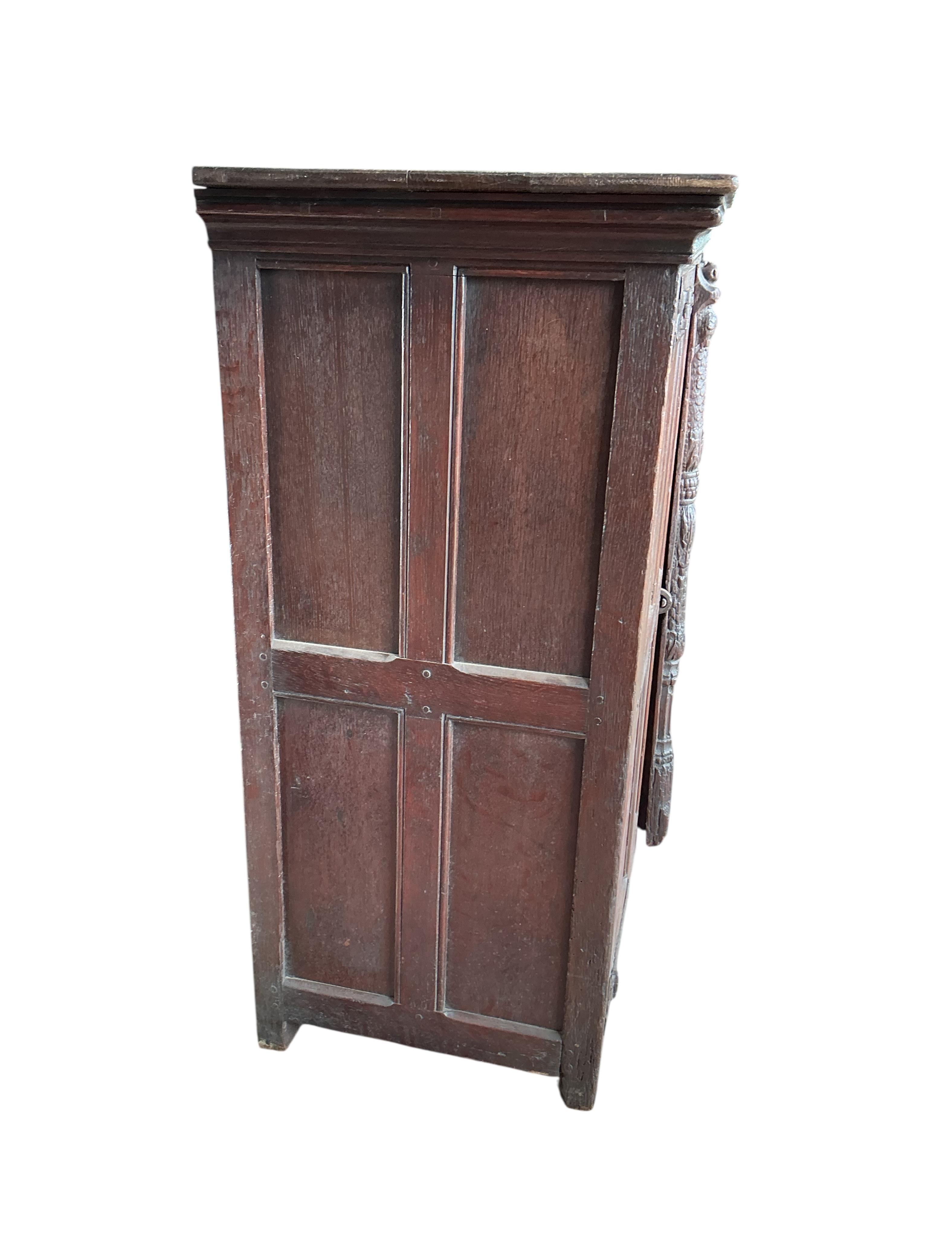 An 18th century and later French carved oak two door cabinet, width 115cm, depth 53cm, height 115cm